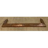 An Arts and Crafts period hammered copper fire curb, characteristically decorated, aperture 116cm