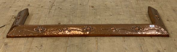 An Arts and Crafts period hammered copper fire curb, characteristically decorated, aperture 116cm