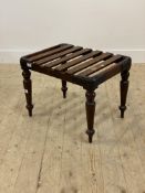 A Victorian mahogany and metal bound luggage stand, with slatted top and turned supports. H45cm,