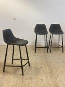 A set of three contemporary bar stools by Dutch bone with black leather upholstered seats, raised on