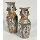 A near pair of 19thc Canton baluster vases, decorated with figures in interior scenes, with gilt shi