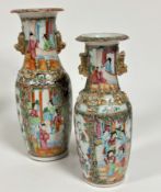 A near pair of 19thc Canton baluster vases, decorated with figures in interior scenes, with gilt shi