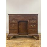 A George III mahogany knee hole desk, late 18th century, the top of rectangular outline over one