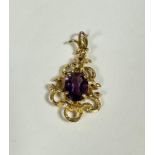 A 9ct gold openwork scrolling pendant set oval faceted amethyst, with textured design (including