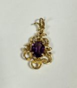 A 9ct gold openwork scrolling pendant set oval faceted amethyst, with textured design (including