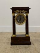 An early 20th century mahogany Portico clock, with gilt metal mounts, enclosing a silvered dial with