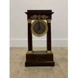 An early 20th century mahogany Portico clock, with gilt metal mounts, enclosing a silvered dial with