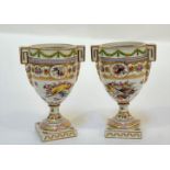 A pair of Dresden porcelain urns, c. 1900, in 18th century style, each moulded and polychrome