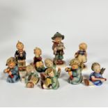 A group of ten various Hummel pottery figures including two Angel candleholders etc. (tallest: