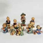 A group of ten various Hummel pottery figures including two Angel candleholders etc. (tallest: