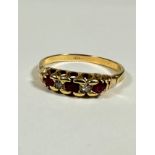 An 18ct gold three stone ruby and two stone diamond point ring mounted in claw setting (S/T) (3.