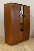 A mid century teak double wardrobe, with mirrored panel to centre, the interior fitted with shelf