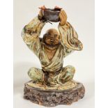 A modern Chinese ceramic figure of a monk with bowl and good fortune bat symbols, the decorated with