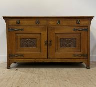 An Arts and Crafts oak sideboard, early 20th century, fitted with two drawers over two fielded and