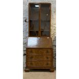 A 1930's figured walnut bureau bookcase, the astragal glazed doors enclosing two shelves, over