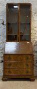 A 1930's figured walnut bureau bookcase, the astragal glazed doors enclosing two shelves, over