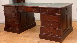A reproduction Georgian style mahogany partners desk, the top inset with green skivered writing