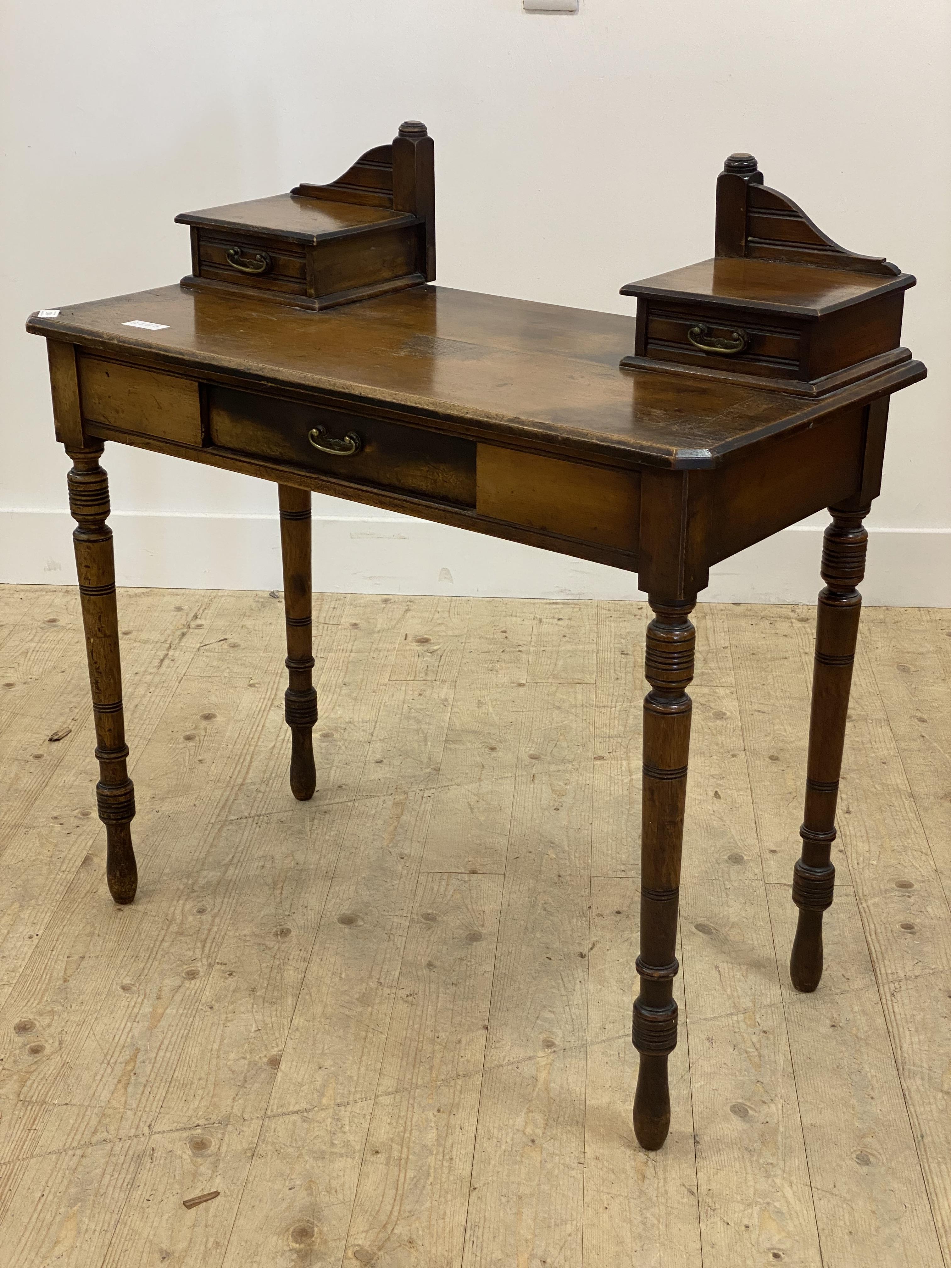 A late Victorian mahogany side table, fitted with three drawers, raised on turned supports (formerly