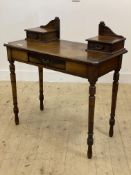 A late Victorian mahogany side table, fitted with three drawers, raised on turned supports (formerly