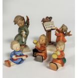 A collection of five Hummel Angel figures including two Trumpeters, Banjo player, a figure holding a