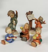 A collection of five Hummel Angel figures including two Trumpeters, Banjo player, a figure holding a