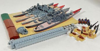 A set of five Triang Minic model toy battleships (largest l- 22cm) and associated accessories