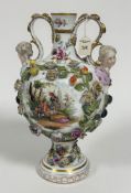A 19thc Meissen twin handled mask vase of baluster form decorated with handpainted romantic scenes