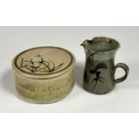A studio pottery small jug decorated with leaf and flower design (chips to rim/spout) (h- 13cm)