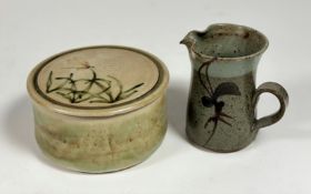 A studio pottery small jug decorated with leaf and flower design (chips to rim/spout) (h- 13cm)