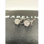 A pair of Abelini diamond stud earrings mounted in platinum, round brilliant, colour H to I,