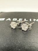 A pair of Abelini diamond stud earrings mounted in platinum, round brilliant, colour H to I,