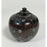 A Japanese Meji period cloisonne ginger jar with stylised butterfly and flower scrolling design