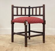 An early 20th century bobbin turned beech wood corner chair in the manner of William Morris, with