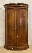 A Victorian figured walnut bow front twin wardrobe, the panelled doors with boxwood stringing