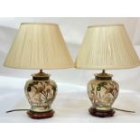 A pair of Rochamp ginger jar style table lamps decorated with a crane scene raised on a circular
