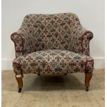 An early 20th century upholstered armchair, moving on castors. H76cm, W75cm, D80cm
