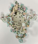 A 19thc porcelain Dresden style rococo scalloped frame wall mirror with scrolling leaf surmount