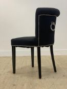 A contemporary side chair by Eichholtz, covered in studded and buttoned wool, raised on square