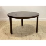 An Italian stained hardwood dining table, the circular top over three square section supports H71cm,