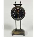 An Edwardian portico style clock with twin urn finials to top and drum head movement, raised on twin