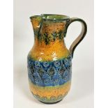 A Continental pottery incised decorated moulded jug, with C scroll handle to side and shaped