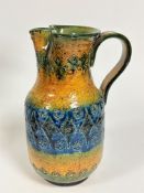 A Continental pottery incised decorated moulded jug, with C scroll handle to side and shaped
