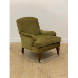 An Edwardian style armchair, upholstered in green chenille fabric, with squab cushion, raised on
