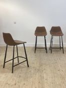 A set of three contemporary bar stools by Dutch bone with brown leather upholstered seats, raised on