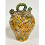 A pottery baluster storage jug with loop handle to top and spout to side, with air vent to right,