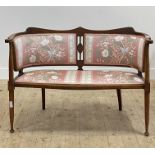 An Edwardian upholstered beech framed drawing room sofa, raised on turned supports. H83cm, W113cm,