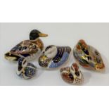 A collection of Royal Crown Derby bone china paperweights comprising a blue resting duck (w-