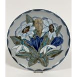 A Highland Stoneware plate decorated with Spring snowdrops and crocuses, signed verso (27cm), no