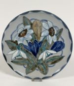 A Highland Stoneware plate decorated with Spring snowdrops and crocuses, signed verso (27cm), no