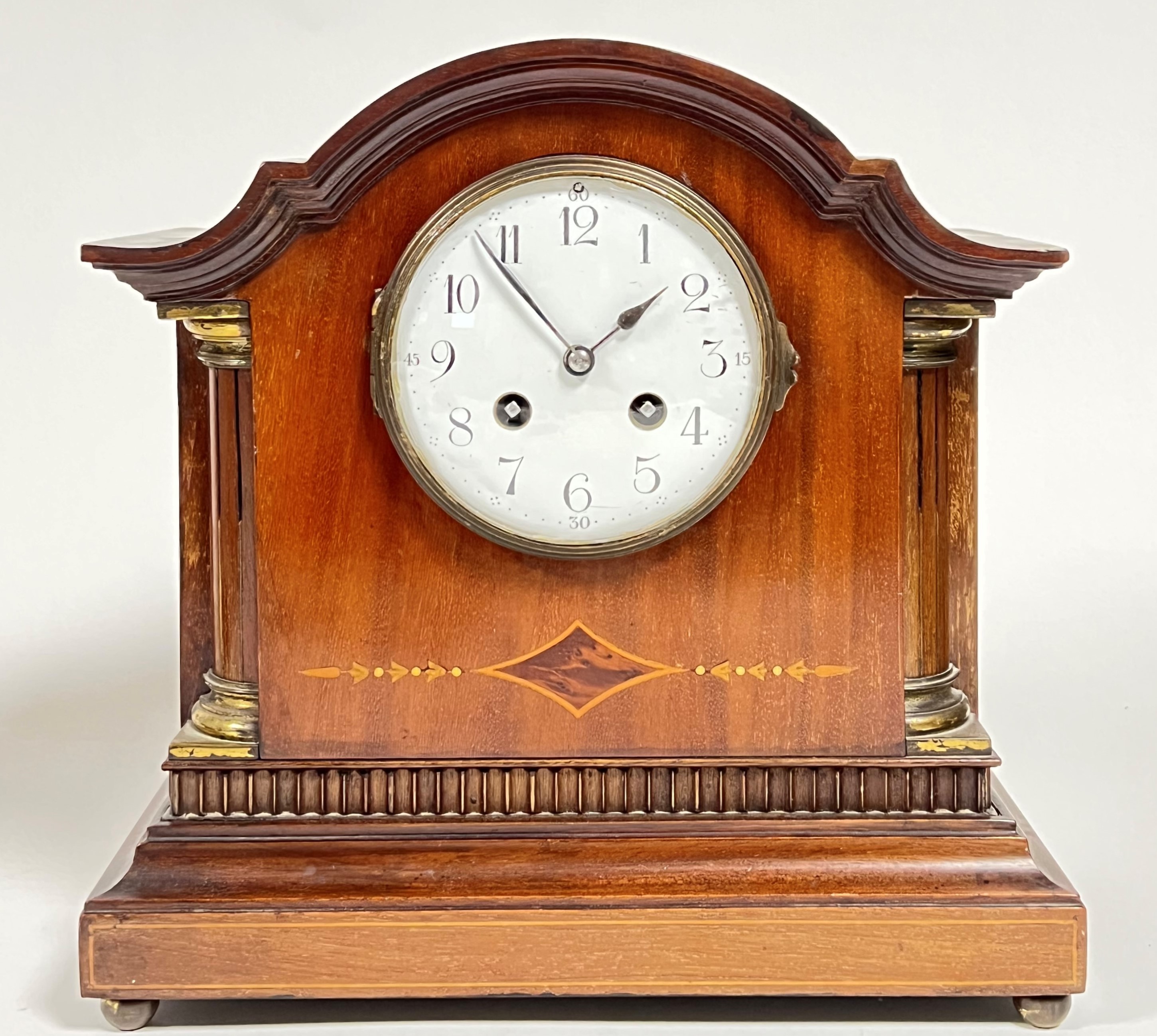 An Edwardian inlaid mahogany 8-day mantle clock, the enamel dial with black Arabic numerals